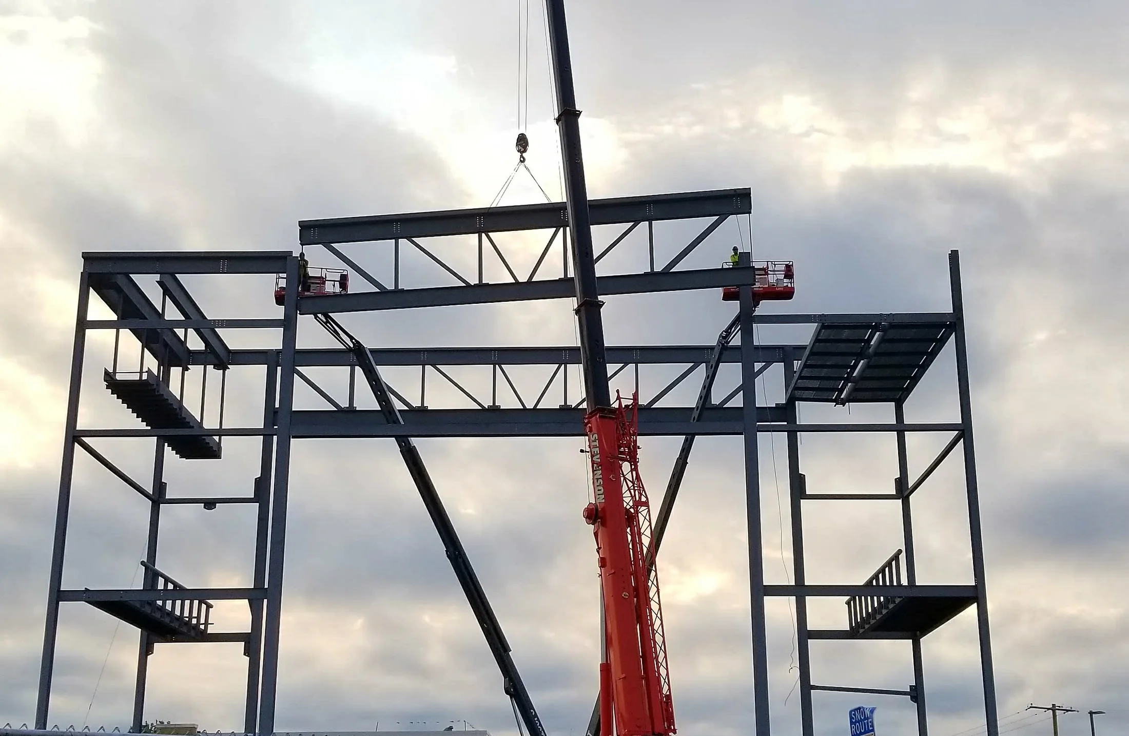 Crane setting structural steel at Oak Lawn High School